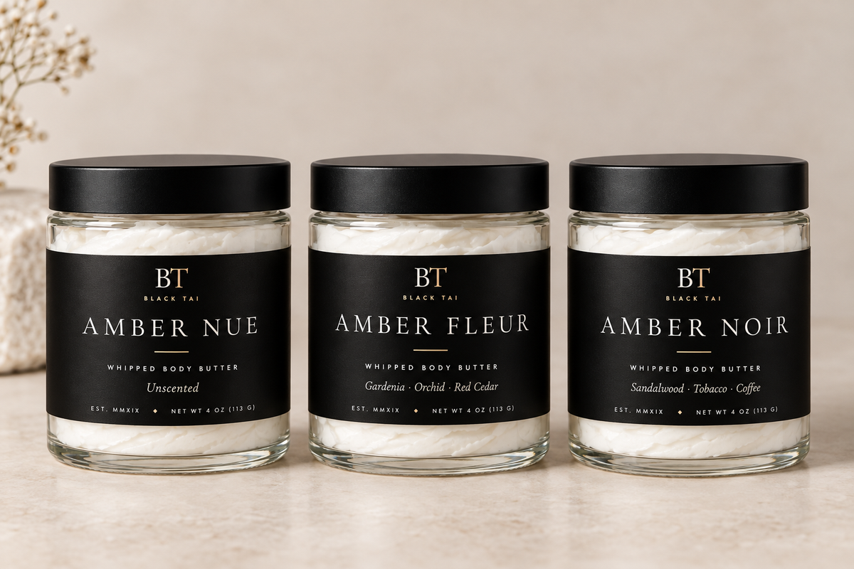 Black Tai whipped body butters, including unscented Amber Nue, in clear glass jars with black lids